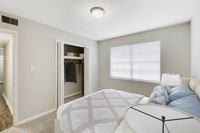 Jonesboro apartment for rent - a bedroom with a bed and a closet with a window