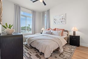 Gilbert apartment for rent - A bedroom with a large bed and a ceiling fan.