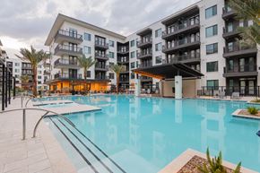 Gilbert apartment for rent - A large swimming pool in front of apartment buildings.