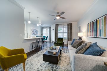 Cary apartment for rent - A living room with a yellow chair and a grey couch.