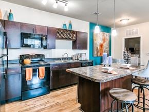 Oklahoma City apartment for rent - a kitchen with black appliances and a granite countertop