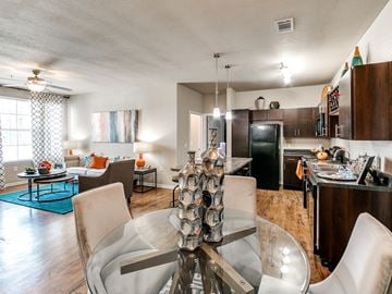 Oklahoma City apartment for rent - a living room and dining room with a glass table and chairs