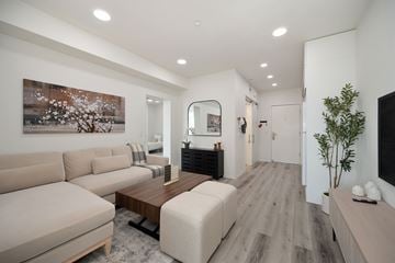 San Diego apartment for rent - A living room with a couch, a coffee table, and a painting on the wall.