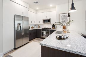 Phoenix apartment for rent - A modern kitchen with a granite countertop and stainless steel appliances.