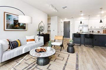 Phoenix apartment for rent - A modern living room with a white sofa and a coffee table.