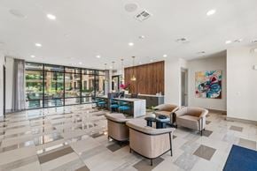 Houston apartment for rent - A spacious lobby with a reception desk and comfortable seating.
