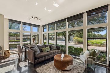 Houston apartment for rent - A living room with a brown couch and a white ottoman.