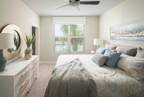 Tampa apartment for rent - A bedroom with a large bed and a painting on the wall.