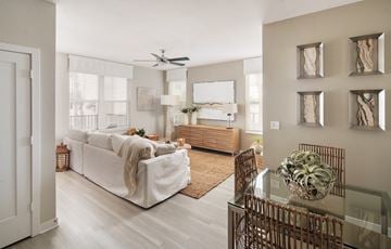 Tampa apartment for rent - A living room with a white couch and a glass table.