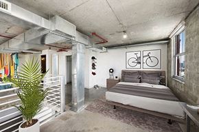 Miami apartment for rent - a bedroom with a bed and a bicycle on the wall