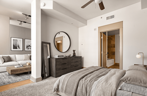 San Diego townhouse for rent - A bedroom with a large bed, a dresser, and a mirror.