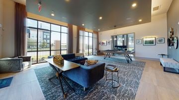 Katy apartment for rent - A living room with a blue couch and a large window.