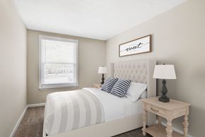 Forest Park apartment for rent - a bedroom with a large bed and a window