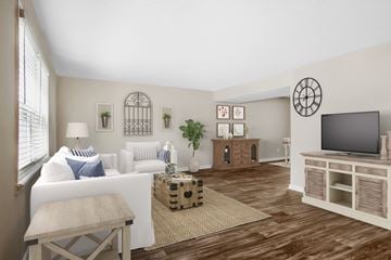 Forest Park apartment for rent - a living room with a white couch and a television