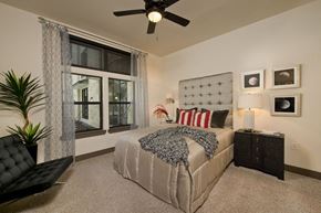 Houston apartment for rent - a bedroom with a bed and a ceiling fan