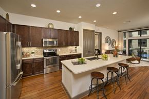 Houston apartment for rent - a kitchen with a large island and stainless steel appliances