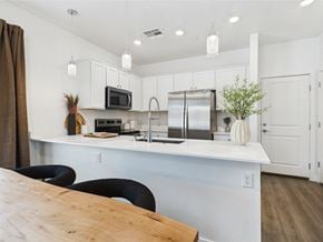 Las Vegas townhouse for rent - A kitchen with a wooden table and black chairs.