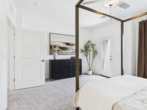 Las Vegas townhouse for rent - A bedroom with a four poster bed and a dresser.