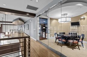 Houston apartment for rent - a dining room with glass walls and a table and chairs