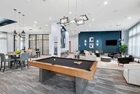 Baytown apartment for rent - A pool table is in the middle of a room with a grey carpet.