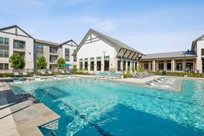 Hockley apartment for rent - A large swimming pool in front of a building with a white roof.