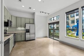 Houston apartment for rent - A kitchen with green cabinets and stainless steel appliances.