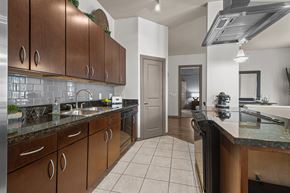Houston apartment for rent - a kitchen with wooden cabinets and granite counter tops
