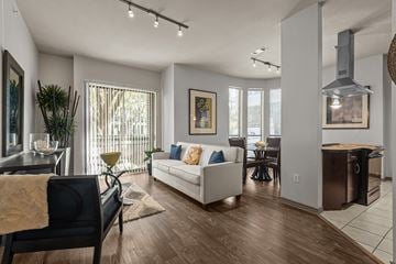 Houston apartment for rent - an open living room and dining room with a couch and a table