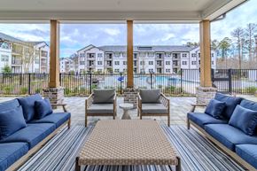 Bloomingdale apartment for rent - A patio with a pool and apartment buildings in the background.