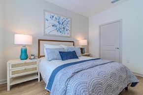 Bloomingdale apartment for rent - A bedroom with a bed, nightstand, and two lamps.