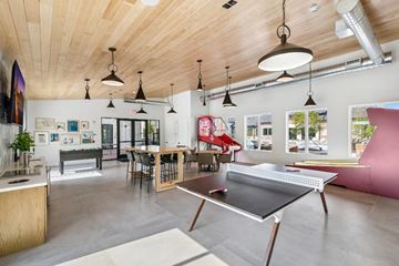Richmond apartment for rent - A ping pong table is in the middle of a room with a wooden ceiling.