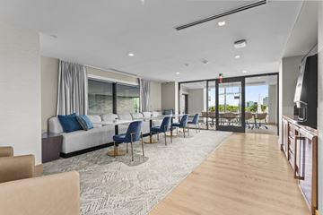 Atlanta apartment for rent - A modern living room with a long couch and chairs.