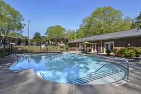 Forest Park apartment for rent - a swimming pool with a house and trees in the background