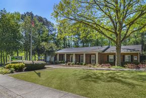 Forest Park apartment for rent - the front of a house with a lawn and trees