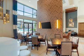 Charlotte apartment for rent - A modern dining room with a wooden patterned wall and a large table with chairs.