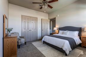 New Braunfels apartment for rent - A bedroom with a large bed and a ceiling fan.