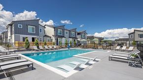 Castle Rock townhouse for rent - A swimming pool surrounded by lounge chairs and apartment buildings.