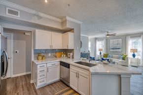 Houston apartment for rent - a kitchen with white cabinets and a large counter top