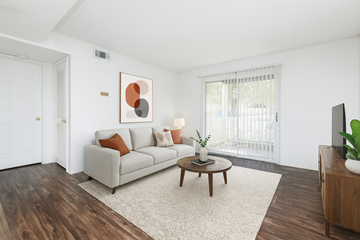 Dickson apartment for rent - A living room with a white couch, a brown coffee table, and a painting on the wall.