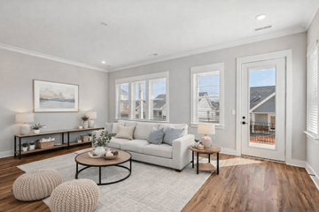 Spring Hill apartment for rent - A living room with a white couch, a coffee table, and a painting on the wall.