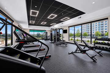 Fort Worth apartment for rent - A gym with treadmills, weights, and exercise equipment.