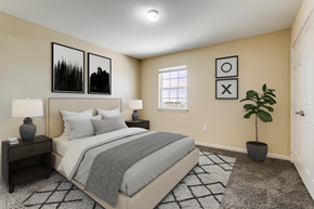 Hobbs townhouse for rent - A bedroom with a bed, nightstands, and a plant.