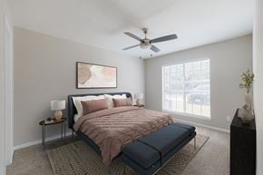 Houston apartment for rent - A bedroom with a bed, nightstand, and a painting on the wall.