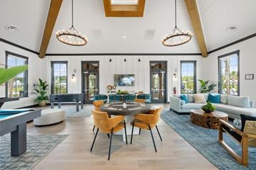 Pooler townhouse for rent - A modern living room with a pool table and a dining table.