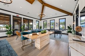 Pooler townhouse for rent - A modern office space with a wooden reception desk and blue chairs.