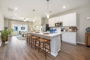 Pooler townhouse for rent - A kitchen with white cabinets and wooden floors.