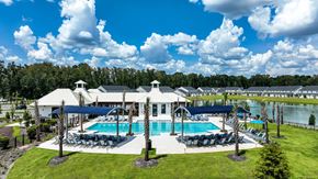Pooler townhouse for rent - A large white building with a pool in front of it.