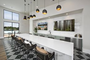 Atlanta apartment for rent - A modern kitchen with a long white counter and black and white tiled flooring.