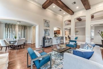 Kingwood apartment for rent - A living room with a blue couch and a coffee table.