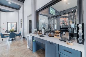 Kingwood apartment for rent - A kitchen with blue chairs and a counter with a coffee maker on it.
